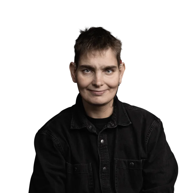 Simon Guichard Person with short hair and black jacket smiling facing the camera