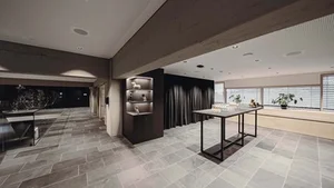 Modern room with tables, windows, and decorative shelves