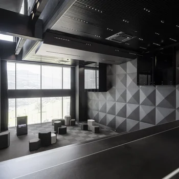 Modern auditorium with geometric walls and flexible seating