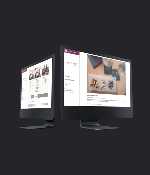 Zwei Bildschirme mit geöffneter Hotel-Website auf dunklem Hintergrund