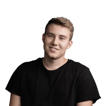 Junger Mann mit kurzem blondem Haar und schwarzem T-Shirt lächelnd vor weißem Hintergrund
