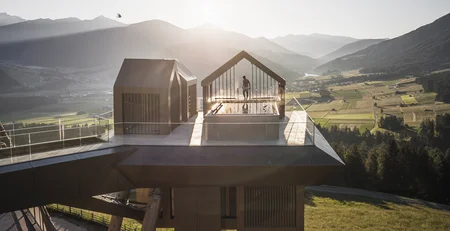 Modern platform with pool overlooking mountains and valley at sunset