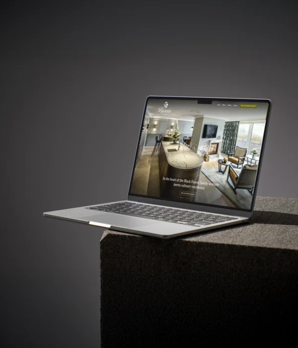 Hotel Bareiss: precision marketing, the highest standards Laptop displaying a website featuring a modern living room and kitchen