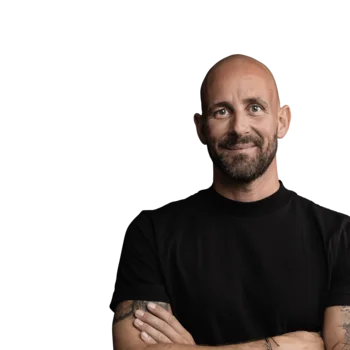 Smiling bald man with tattoos wearing black shirt on white background