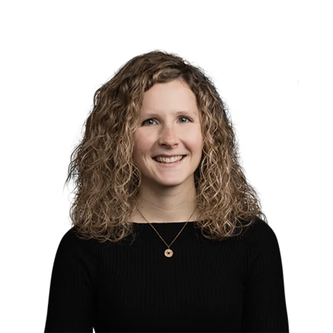 Portrait of smiling woman with curly hair wearing black top