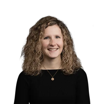 Portrait of smiling woman with curly hair wearing black top