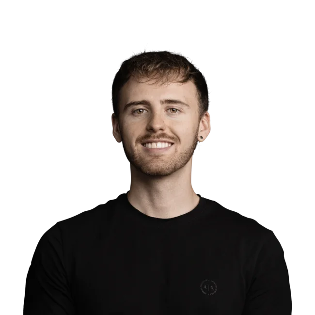 Tobias Stenico Young man with short brown hair and black shirt smiling on white background