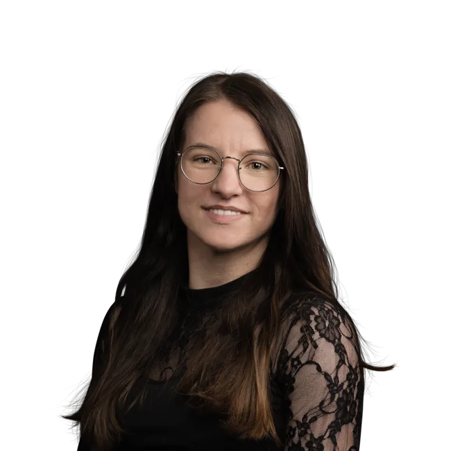 Portrait of a smiling young woman with glasses and long brown hair