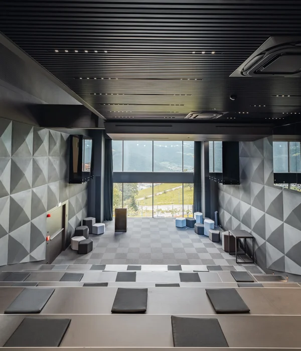 Modern lecture hall with geometric wall patterns and large windows