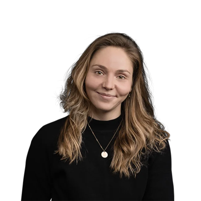 Young woman with long blonde hair and black sweater smiling
