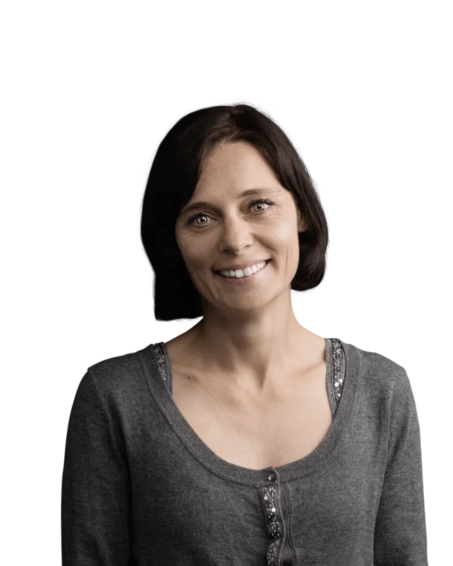 Barbara Zöll Smiling woman with short brown hair wearing a grey sweater