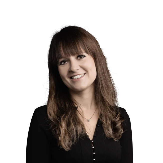 Sara Angerer Portrait of a smiling woman with brown hair wearing a black top