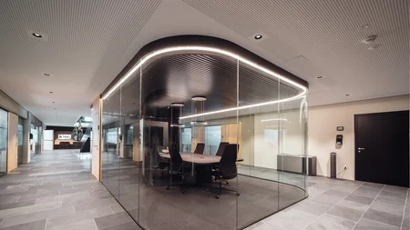 Modern office with glass meeting room and black ceiling