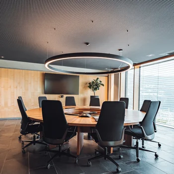 Modern meeting room with round table and large windows