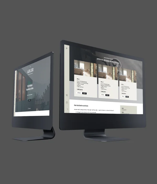 Two computer monitors displaying the Adler hotel website