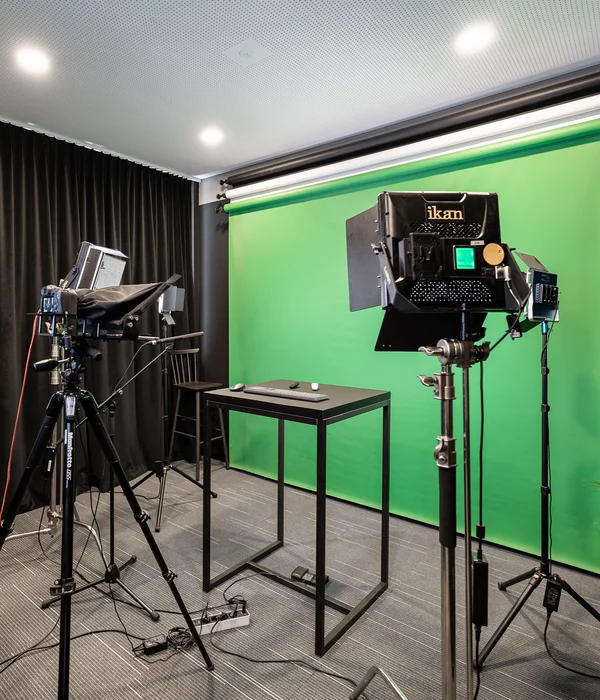 Professional studio with green screen, cameras, and lighting equipment