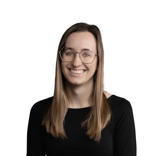 Teresa Mayr Portrait of a smiling woman with glasses and long brown hair wearing a black top