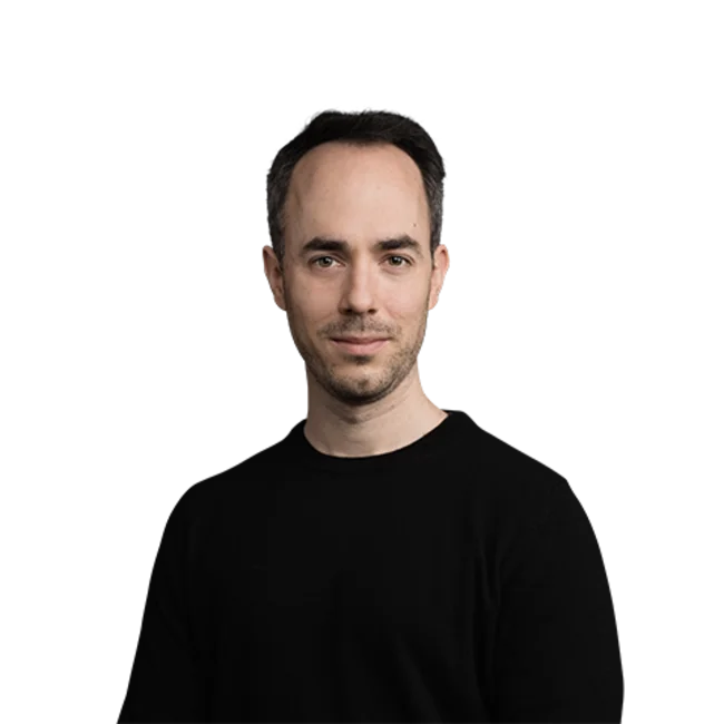 Portrait of a man with short dark hair wearing a black sweater