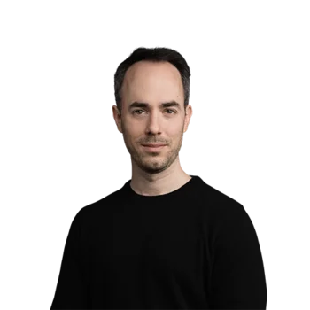 Portrait of a man with short dark hair wearing a black sweater