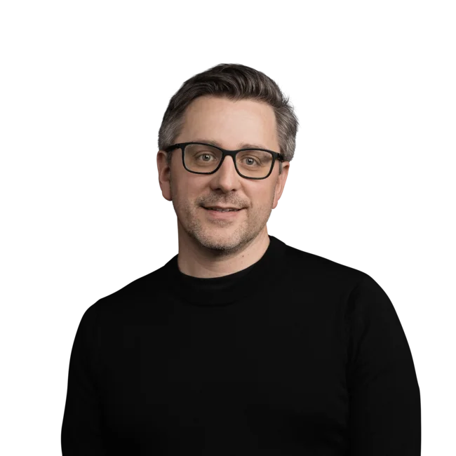 Portrait of a man with glasses in black sweater on white background