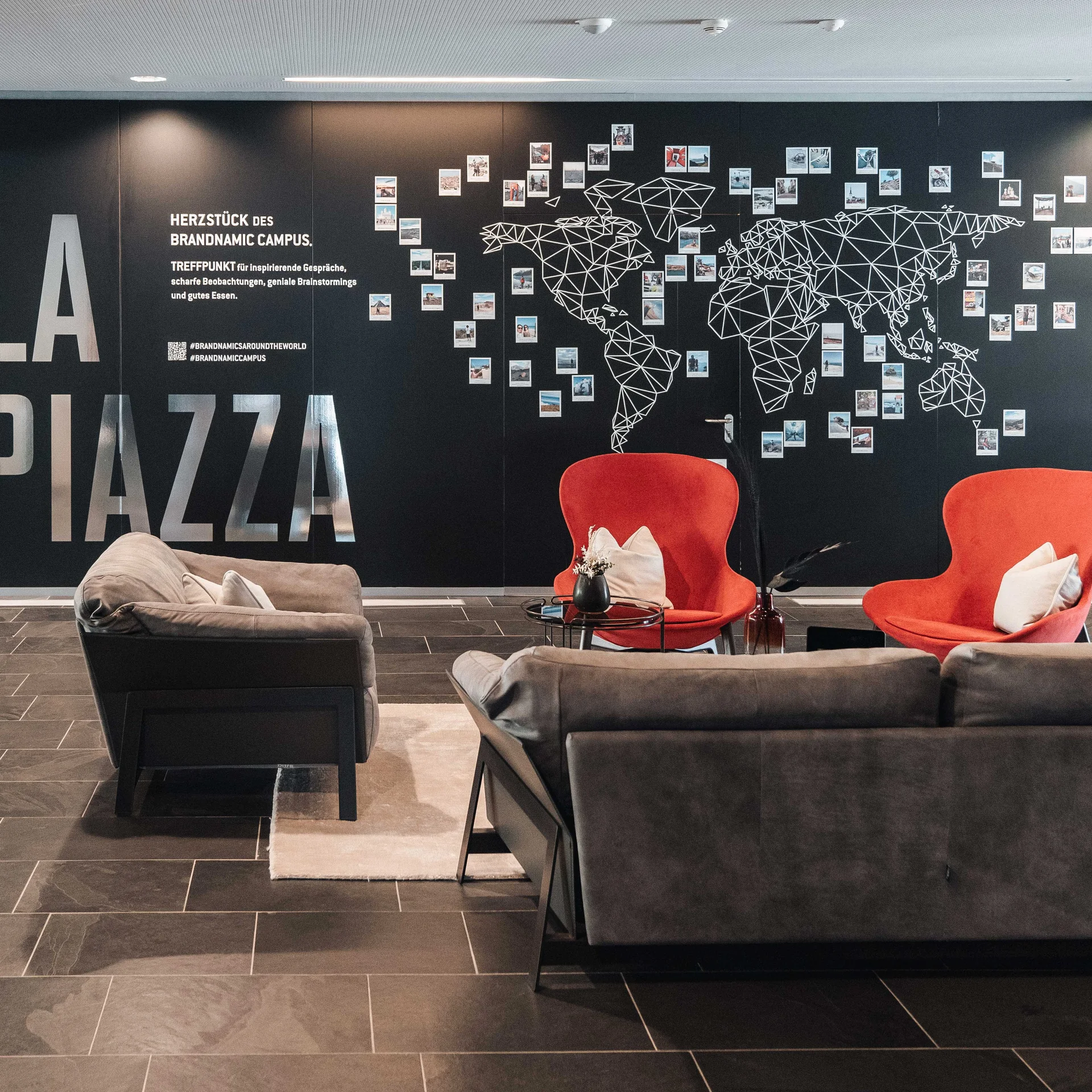 Modern lobby with seating area and world map on the wall