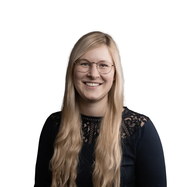 Christiane Unglert Woman with long blonde hair, glasses, and black lace top smiling