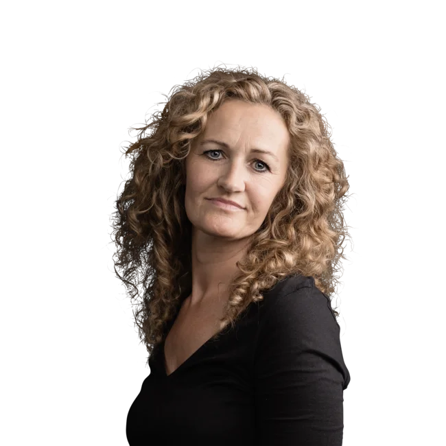 Christine Putzer Frau mit lockigem blonden Haar und schwarzem Oberteil vor weißem Hintergrund