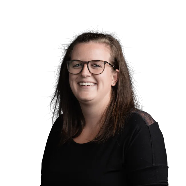 Sara Tratter Smiling woman with glasses and long dark hair on white background