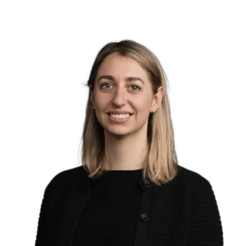 Portrait of smiling woman with shoulder-length blonde hair wearing black clothing
