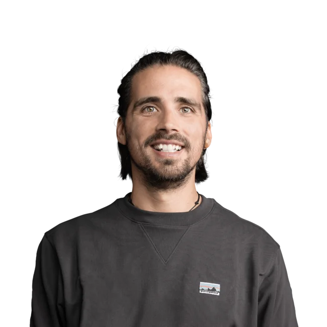 Uomo sorridente con maglione scuro su sfondo bianco