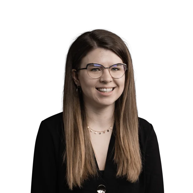 Young woman with glasses and long hair smiling on white background