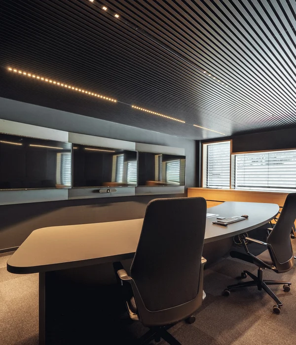 Modern meeting room with large screens and ergonomic chairs