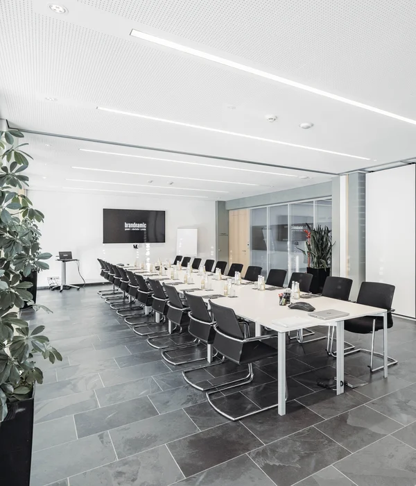 Modern conference room with long table and black chairs