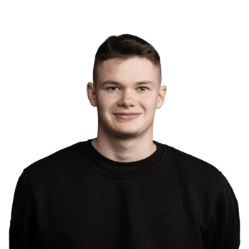 Junger Mann mit kurzem braunem Haar und schwarzem Pullover lächelt