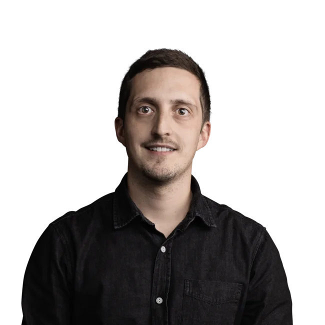 Ramon Zemmer Portrait of a smiling man wearing a black shirt on a white background