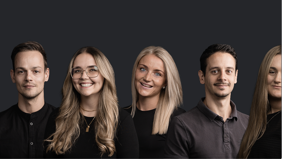 Brandnamic: Hotel solutions from hospitality experts Portrait of a group of five smiling young adults against a dark background